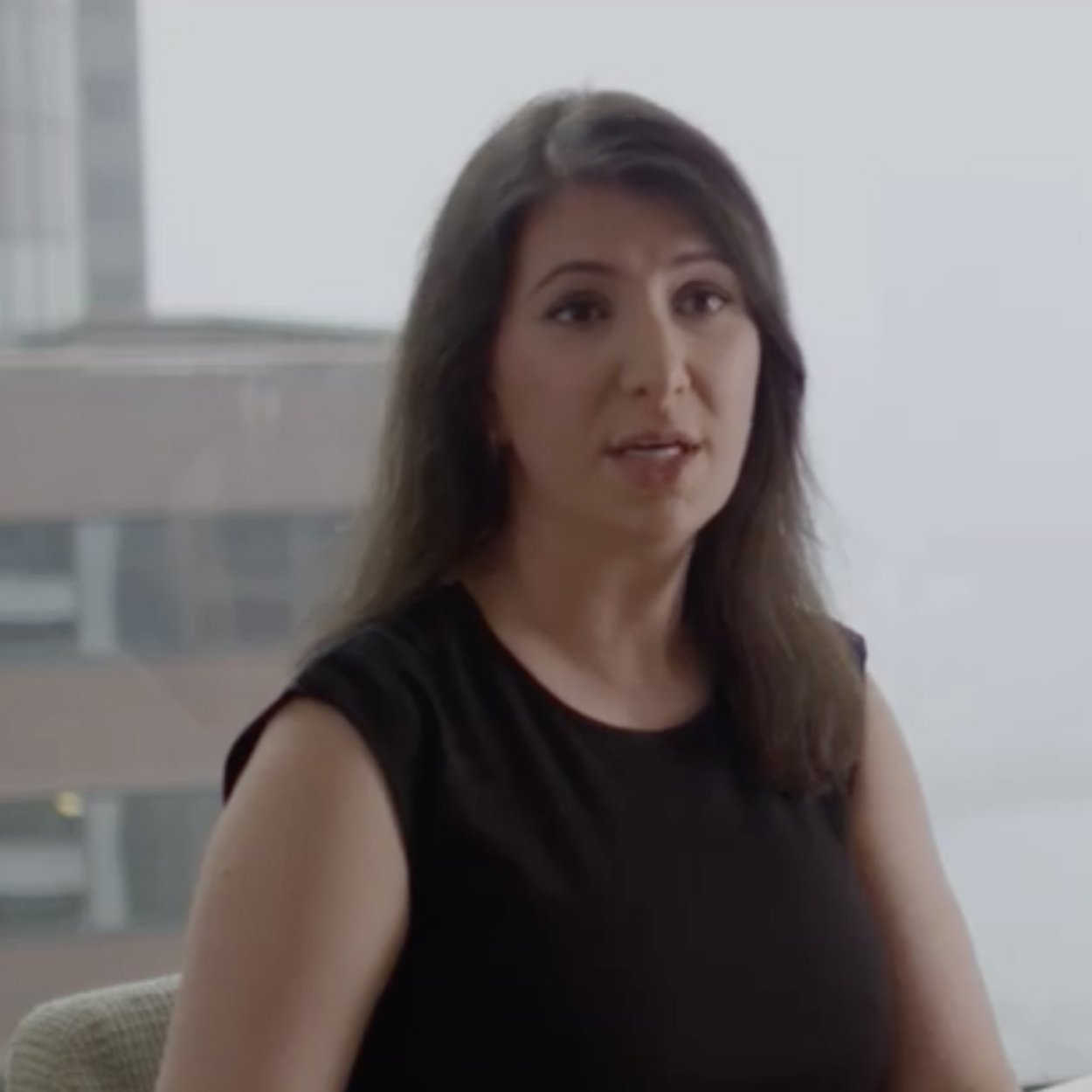 Employee Sitting in Chair Speaking