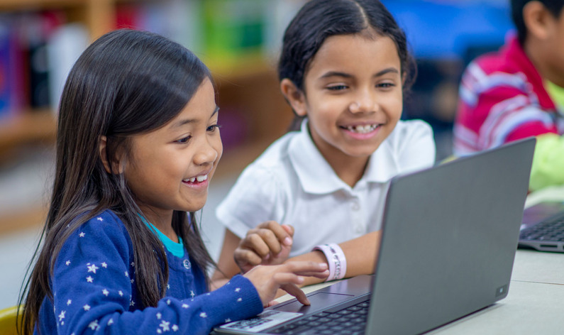 Young Students Looking at a Laptop