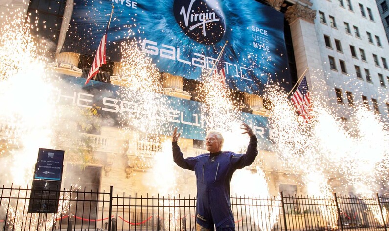 Richard Branson Standing in Front of Fireworks